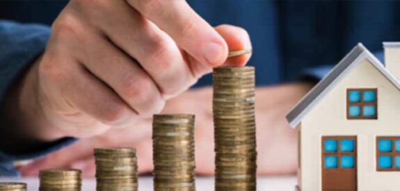 counting coins near an image of a house