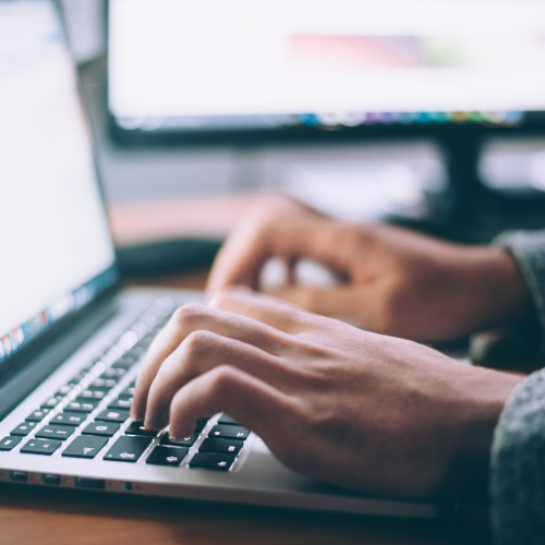 Person typing on computer.