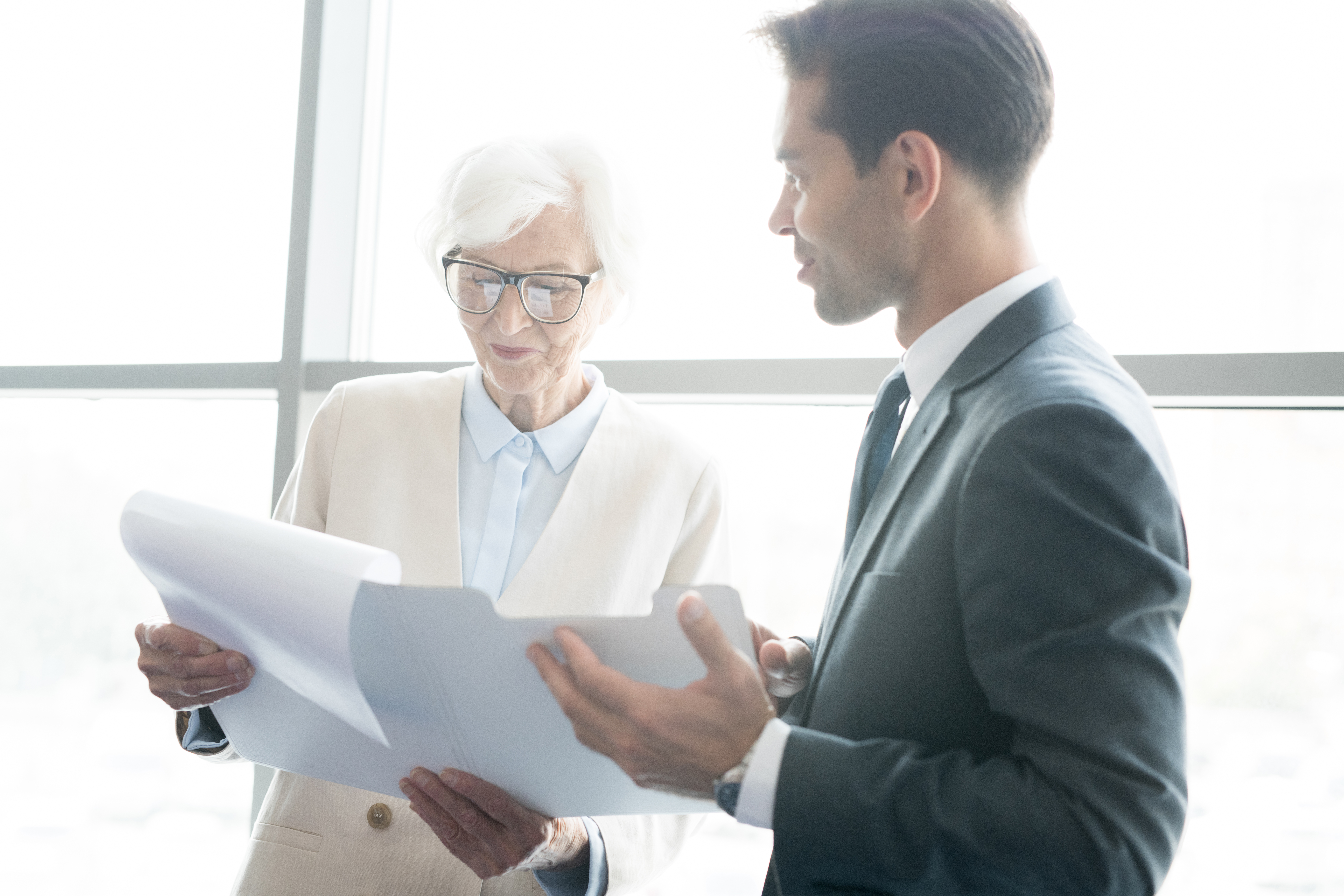 Broker going over paperwork/plan with younger agent